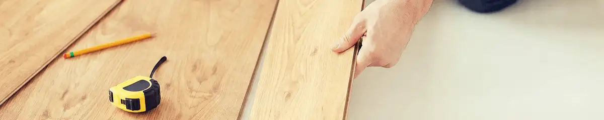 A professional installing wood flooring in Grand Rapids, MI