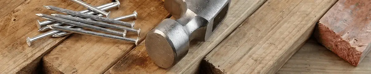 Hammer and nails on hardwood flooring boards in Grand Rapids, MI