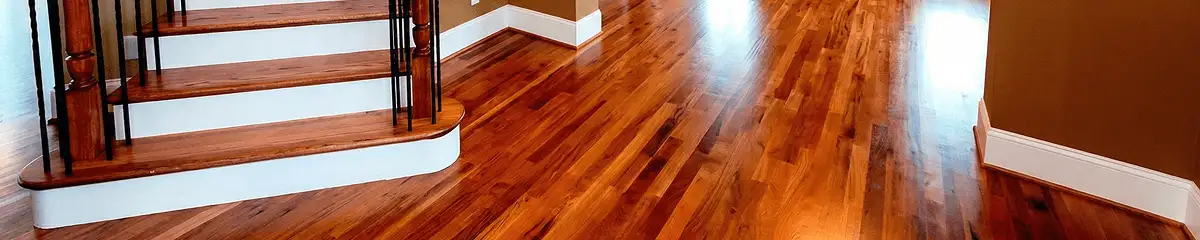 Base floor of a staircase with professionally restored wood flooring in Grand Rapids MI