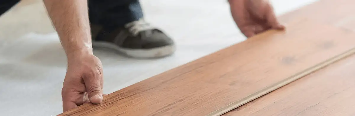 A professional installing laminate flooring in Grand Rapids, MI