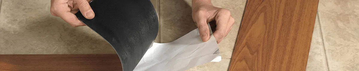 A professional installing vinyl flooring in Grand Rapids, MI