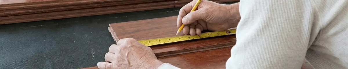 A professional installing wood flooring in Grand Rapids, MI